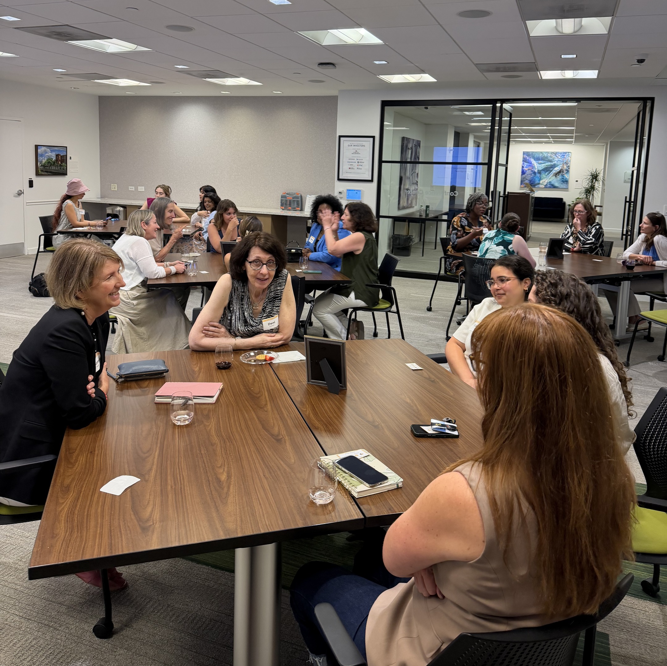 Women in conversation at a table during a small-group rotation